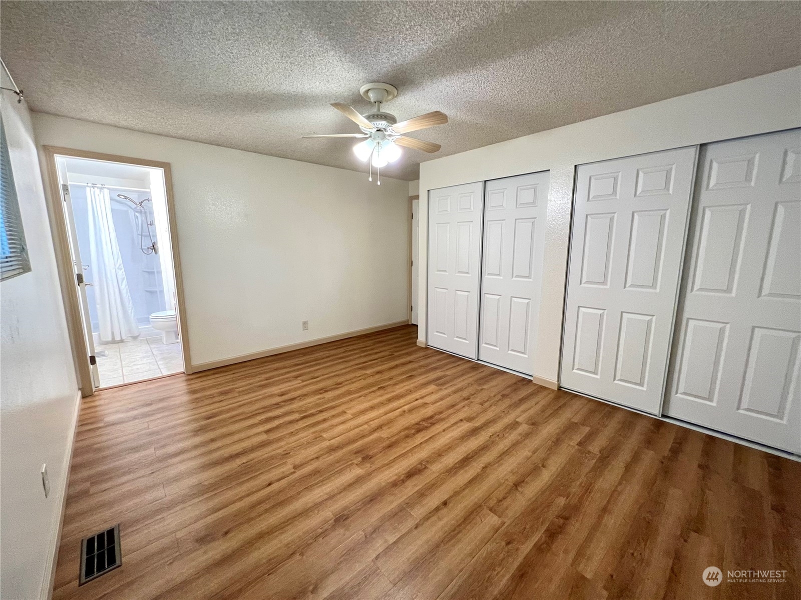 8 156th Place Southwest Bothell, WA 98012 - Photo 13 of 33 wooden floor in an empty room with a window