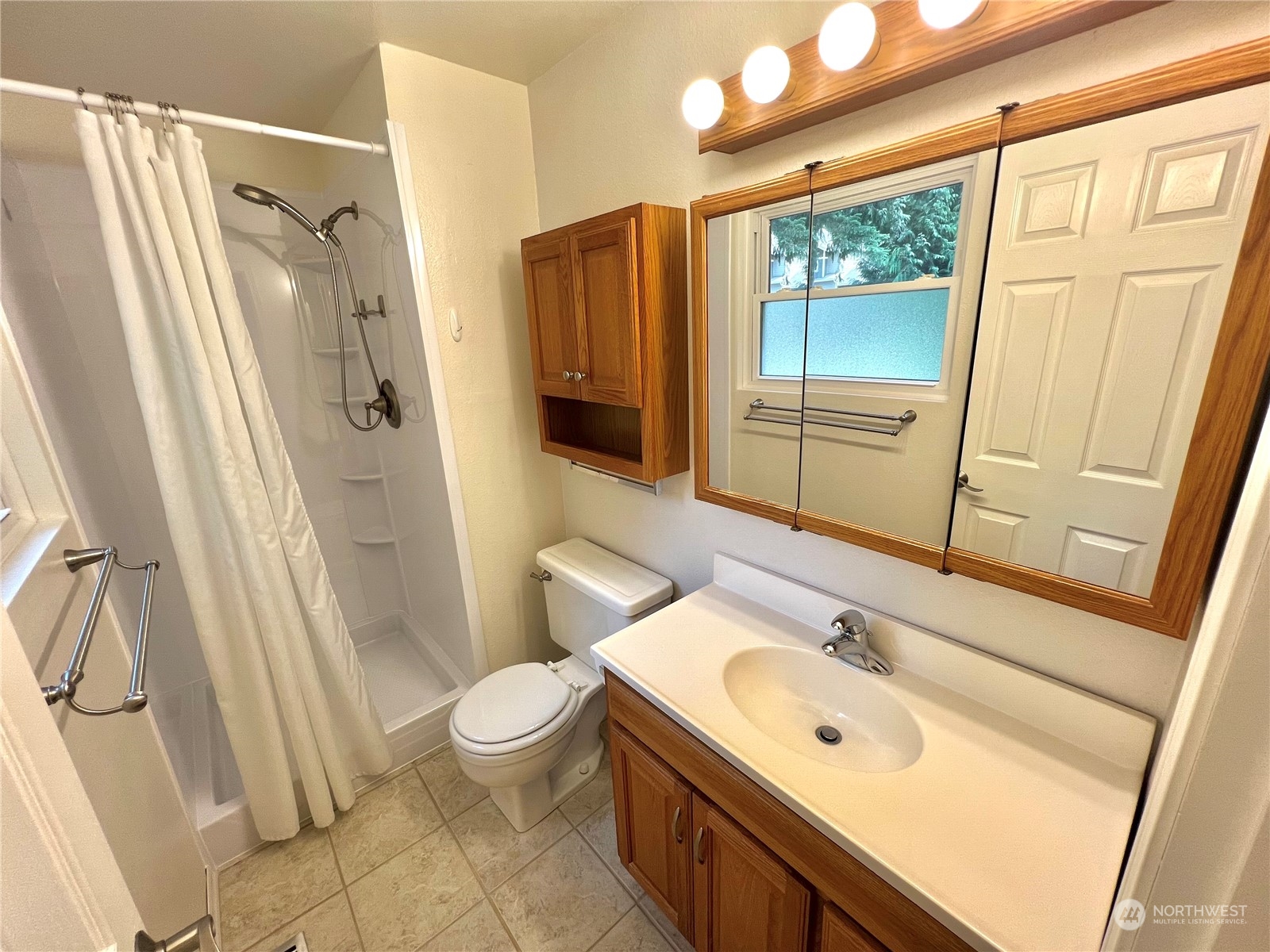 8 156th Place Southwest Bothell, WA 98012 - Photo 14 of 33 a bathroom with a sink a mirror a toilet and shower