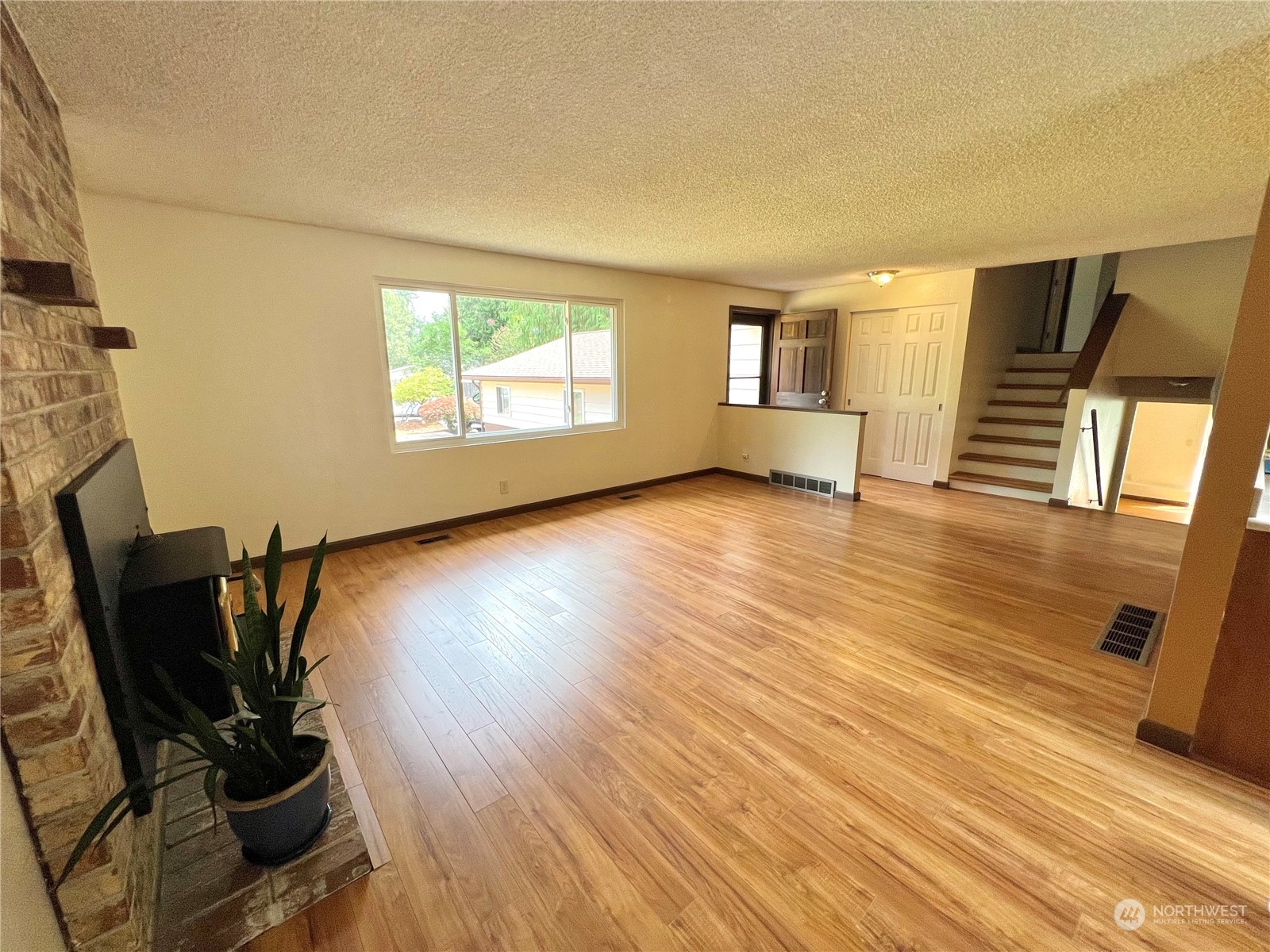 8 156th Place Southwest Bothell, WA 98012 - Photo 7 of 33 a view of a room with wooden floor and a window