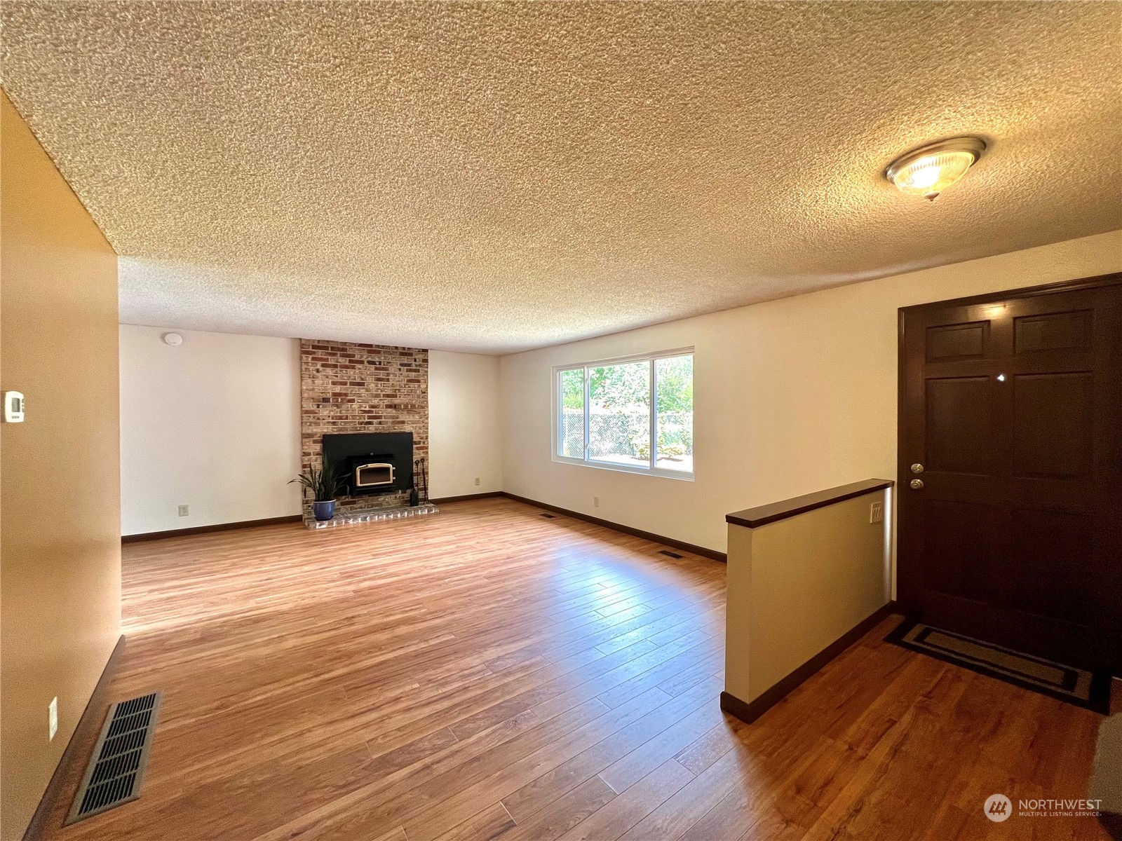 8 156th Place Southwest Bothell, WA 98012 - Photo 8 of 33 an empty room with windows and fireplace