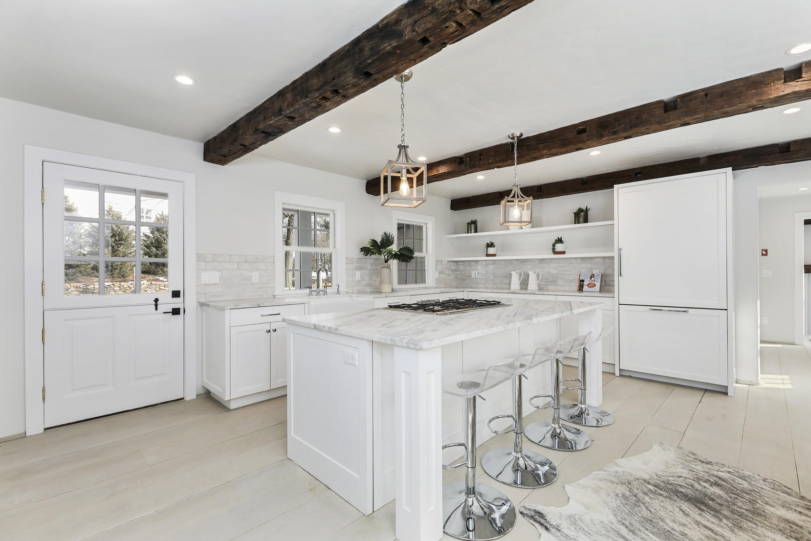 25 Brookside Road Darien, CT 06820 - Photo 3 of 30 a kitchen with granite countertop a white cabinets and refrigerator