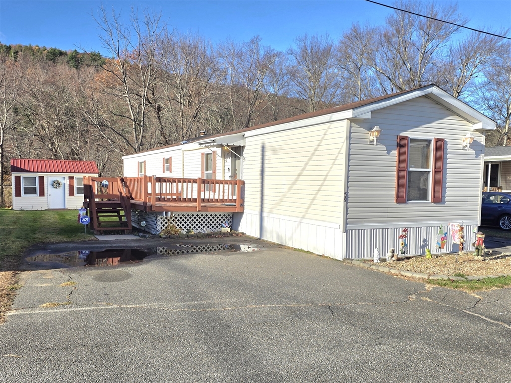 268 Palmer Road, Unit 59 Monson, MA 01057 - Photo 1 of 27 a view of a house with a outdoor space