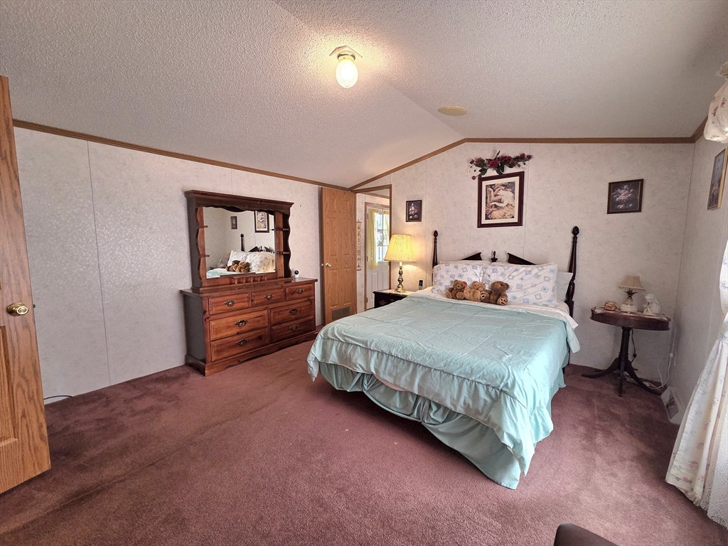 268 Palmer Road, Unit 59 Monson, MA 01057 - Photo 11 of 27 a spacious bedroom with a bed and a dresser