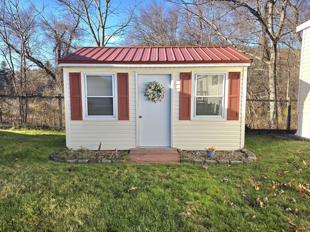 268 Palmer Road, Unit 59 Monson, MA 01057 - Photo 20 of 27 a front view of a house with a yard