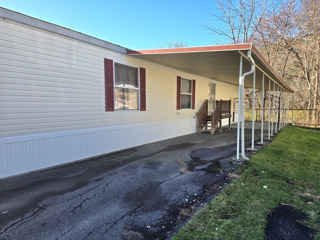 268 Palmer Road, Unit 59 Monson, MA 01057 - Photo 22 of 27 a front view of a house with garden
