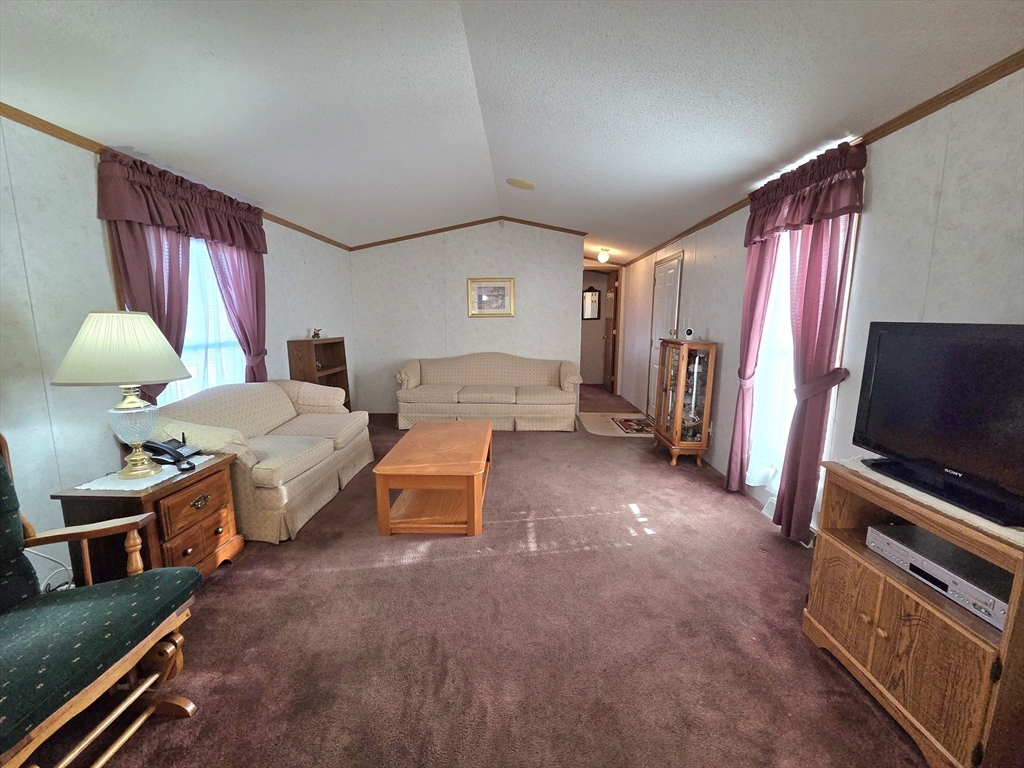 268 Palmer Road, Unit 59 Monson, MA 01057 - Photo 4 of 27 a living room with furniture and a flat screen tv