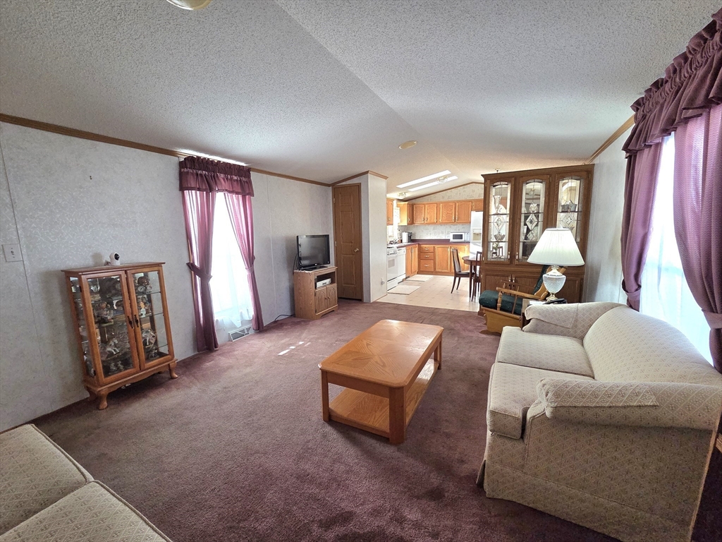 268 Palmer Road, Unit 59 Monson, MA 01057 - Photo 5 of 27 a living room with furniture and a large window
