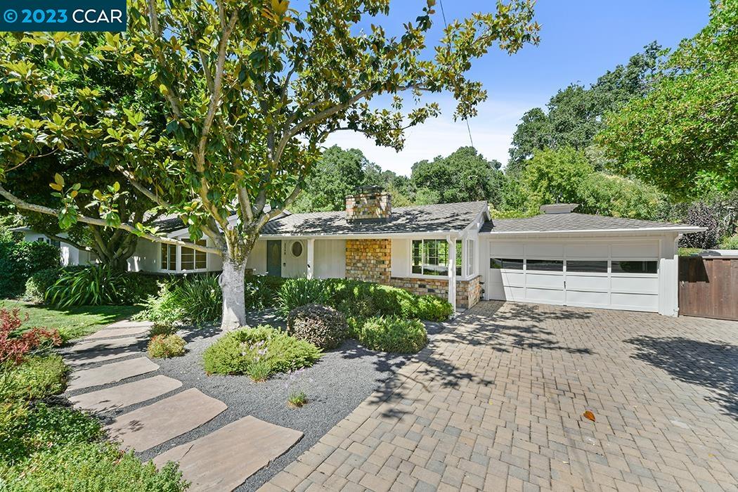 3340 Springhill Road Lafayette, CA 94549 - Photo 1 of 1 a front view of a house with a garden