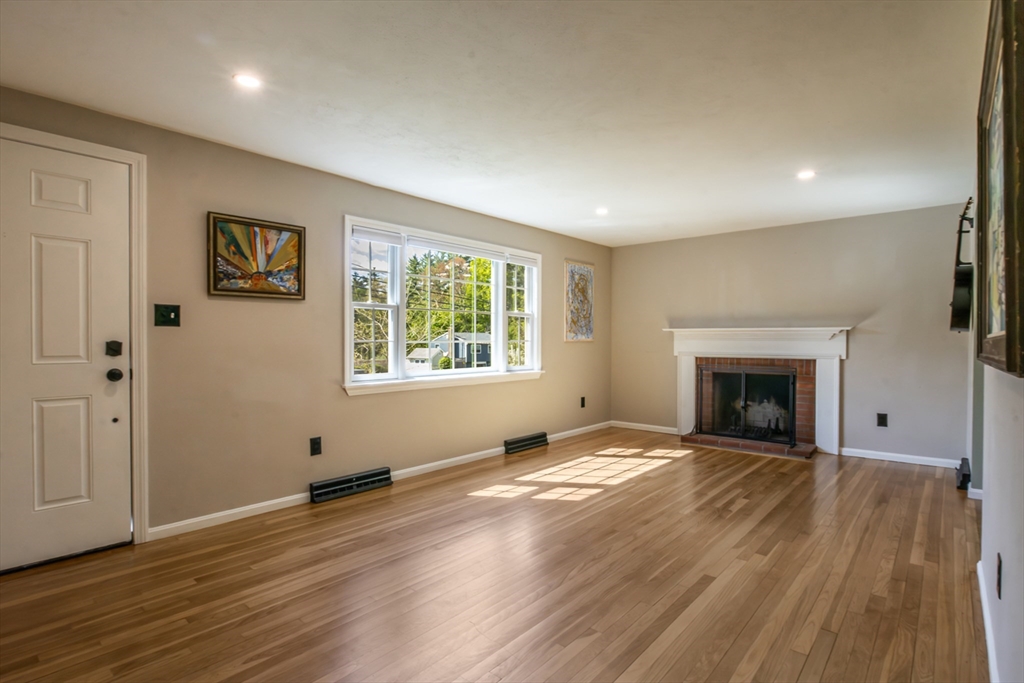 196 Center Street Groveland, MA 01834 - Photo 3 of 32 wooden floor fireplace and windows in an empty room