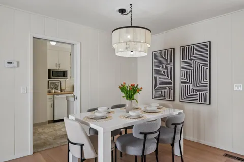 a view of a dining room with furniture wooden floor and chandelier