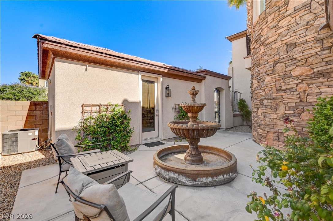 2793 Rosenhearty Drive Henderson, NV 89044 - Photo 59 of 85 This tranquil outdoor space features a decorative fountain and inviting seating for relaxation.
