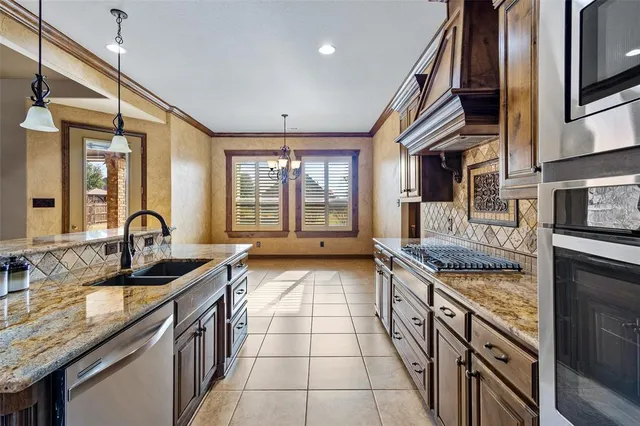 a kitchen with stainless steel appliances granite countertop a sink and stove