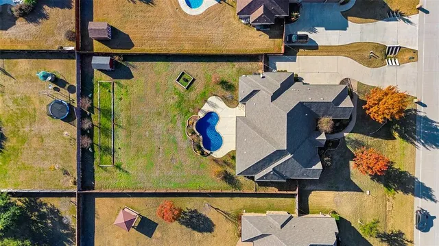 an aerial view of a house with swimming pool