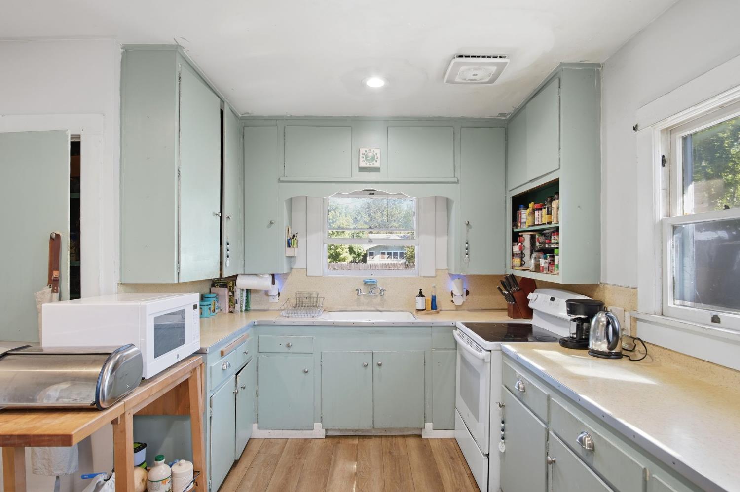 557 Florence Street Turlock, CA 95380 - Photo 12 of 36 a kitchen with a sink stove and cabinets