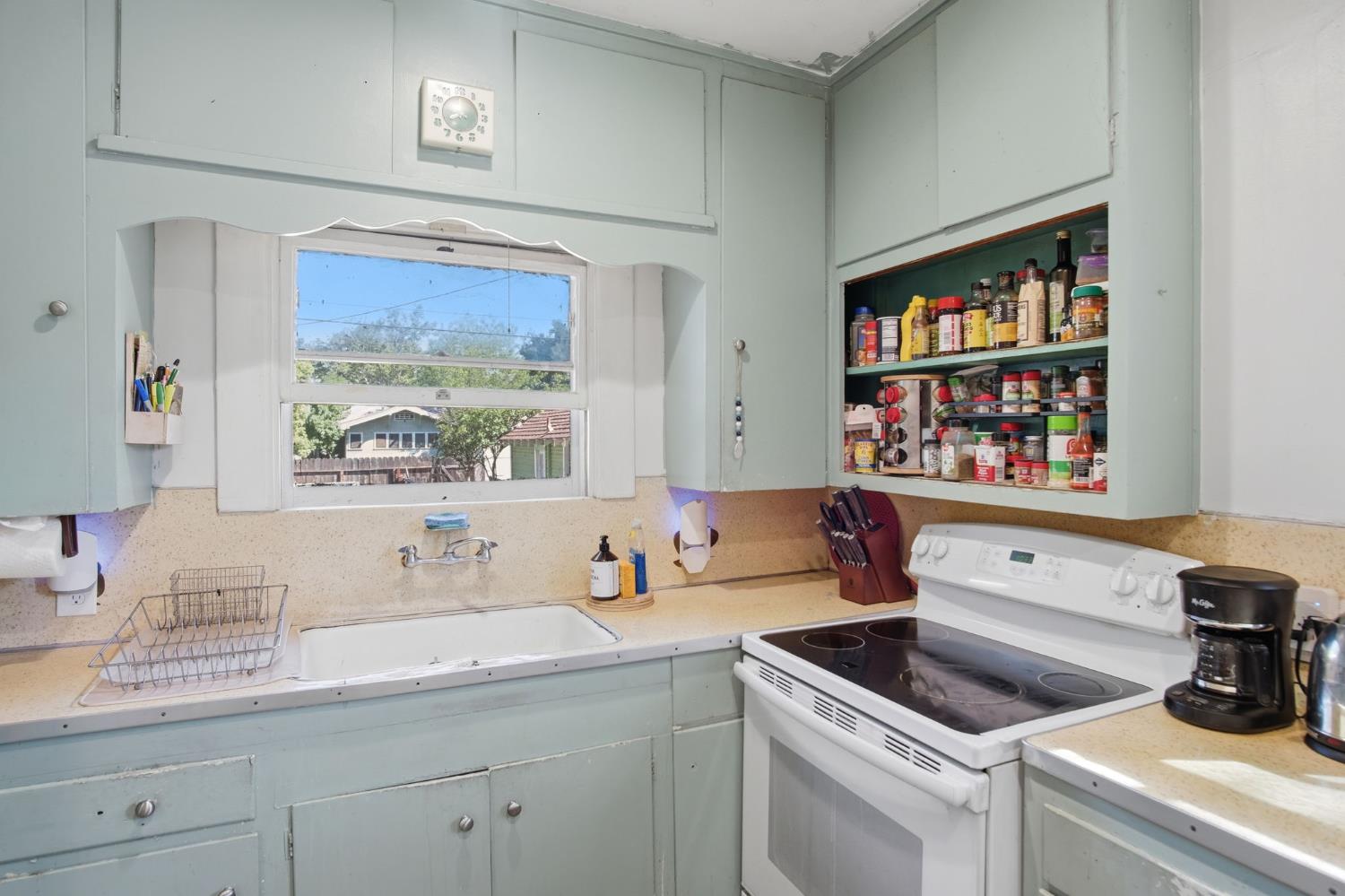 557 Florence Street Turlock, CA 95380 - Photo 13 of 36 a kitchen with a sink cabinets and window
