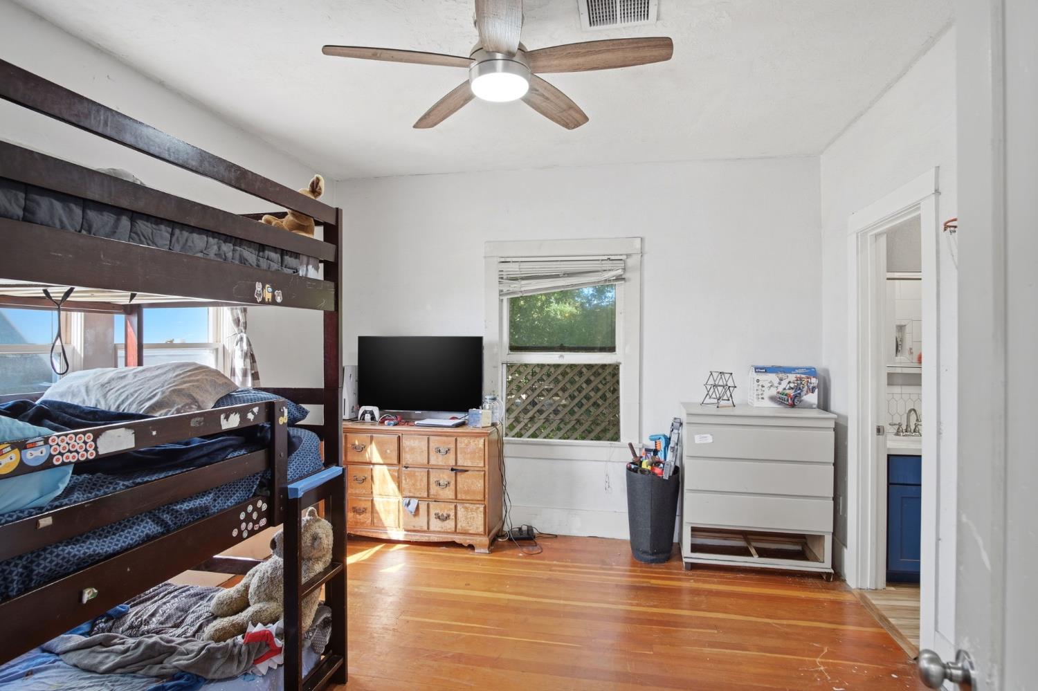 557 Florence Street Turlock, CA 95380 - Photo 14 of 36 a bedroom with furniture and a flat screen tv