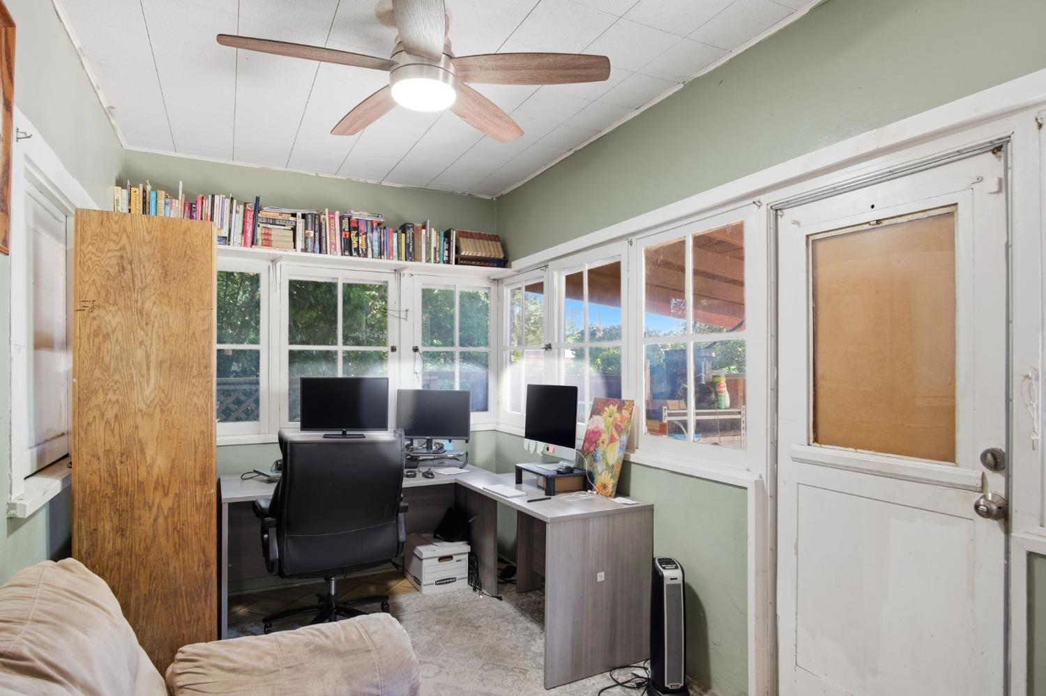 557 Florence Street Turlock, CA 95380 - Photo 19 of 36 a view of a workspace with furniture and a window