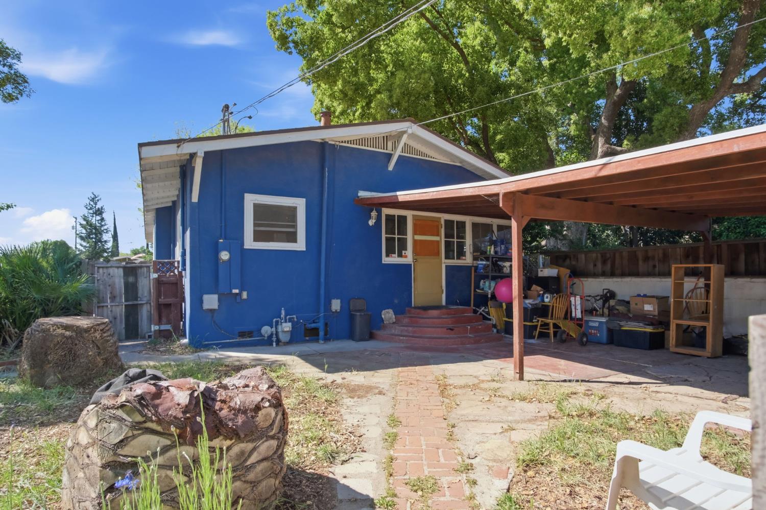 557 Florence Street Turlock, CA 95380 - Photo 22 of 36 a front view of a house with a yard patio and fire pit