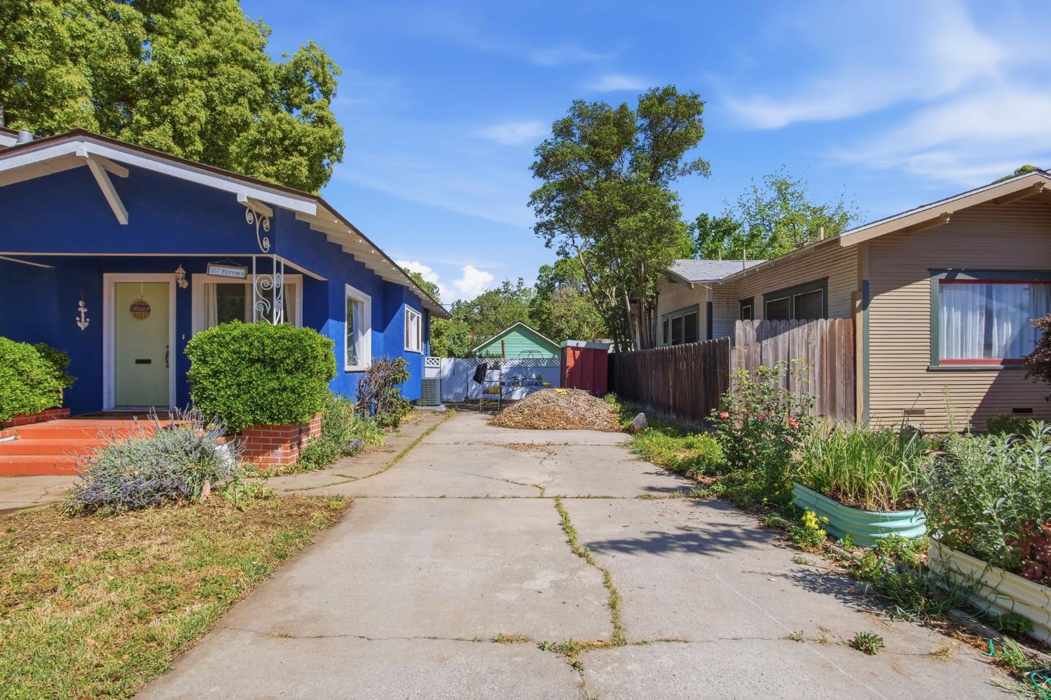 557 Florence Street Turlock, CA 95380 - Photo 4 of 36 a front view of a house with a yard and potted plants