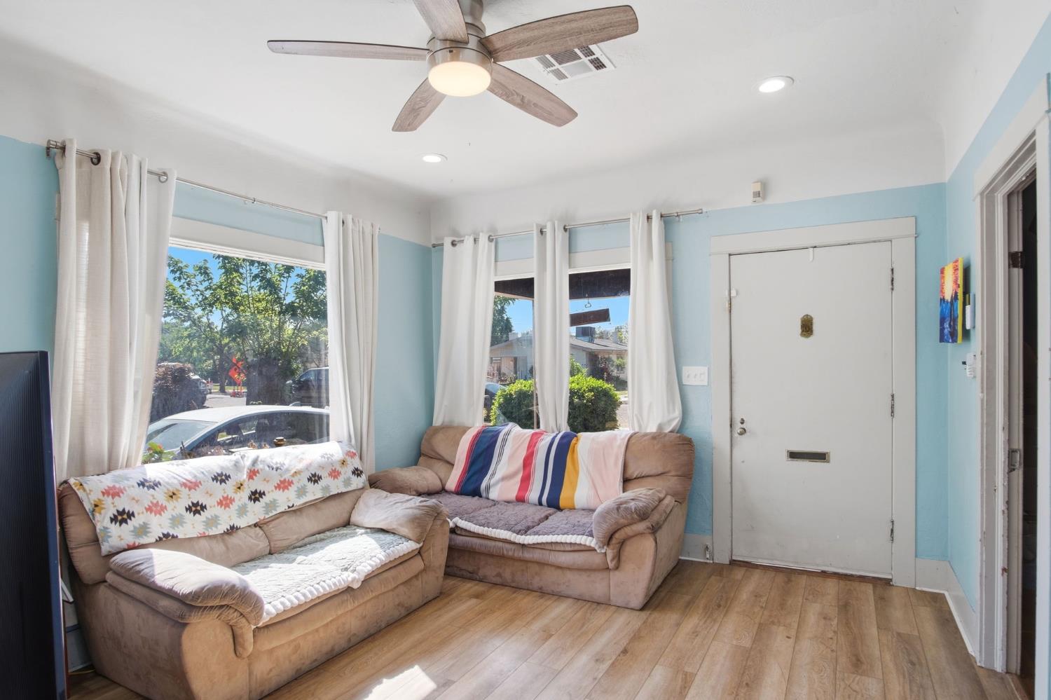 557 Florence Street Turlock, CA 95380 - Photo 5 of 36 a living room with furniture and a large window