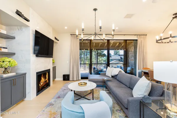 a living room with furniture a fireplace and a flat screen tv