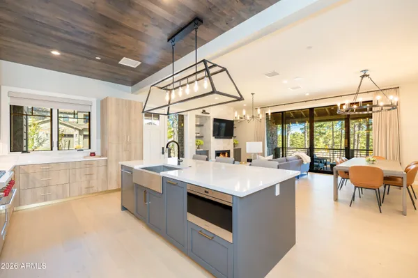 a kitchen with stainless steel appliances granite countertop a sink a stove and a refrigerator