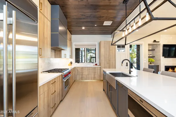 a spacious bathroom with a double vanity sink mirror and bathtub