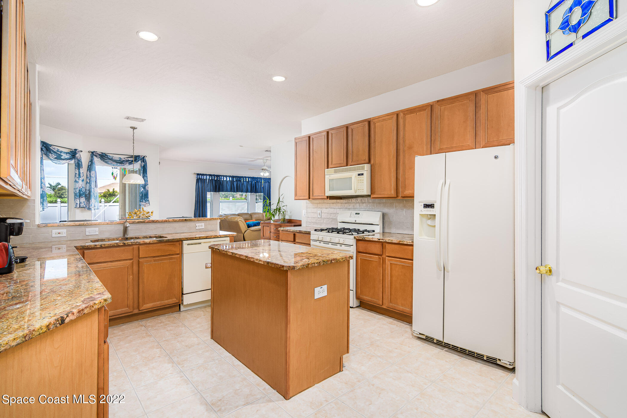 3832 Stream Drive Melbourne, FL 32940 - Photo 11 of 63 a kitchen with stainless steel appliances granite countertop a refrigerator stove and sink