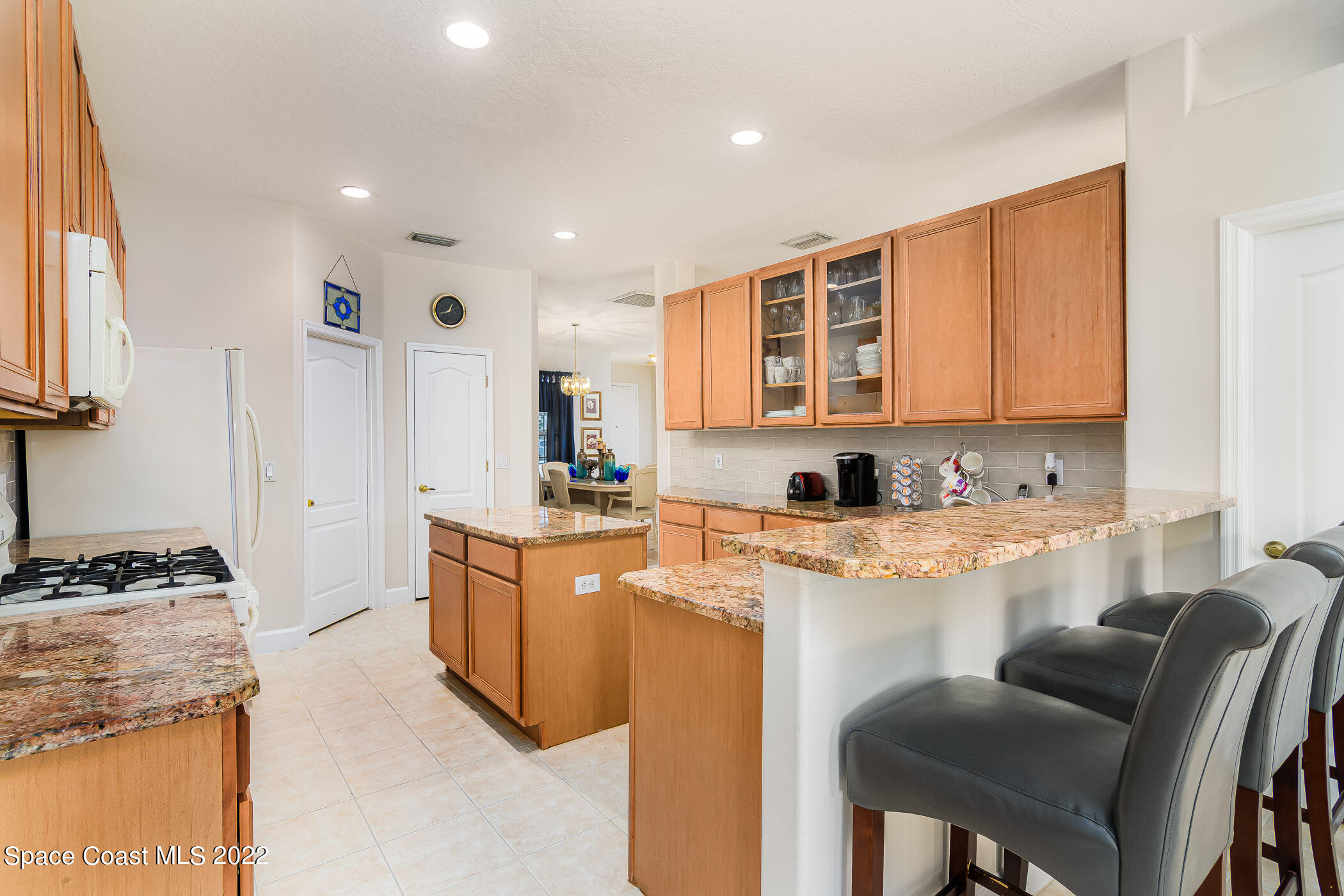 3832 Stream Drive Melbourne, FL 32940 - Photo 13 of 63 a kitchen with stainless steel appliances granite countertop a stove a sink dishwasher and a refrigerator