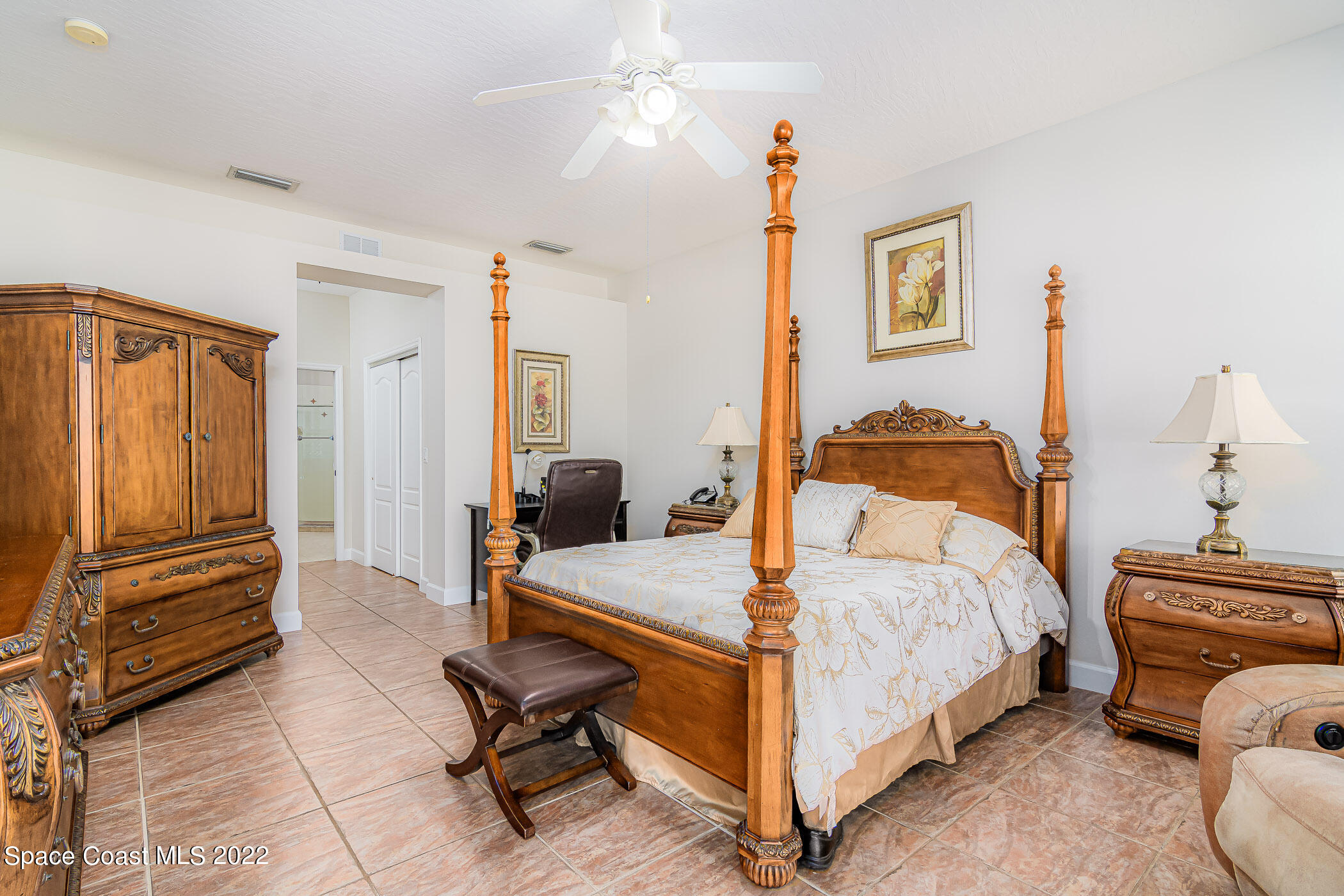 3832 Stream Drive Melbourne, FL 32940 - Photo 18 of 63 a bedroom with a bed and furniture