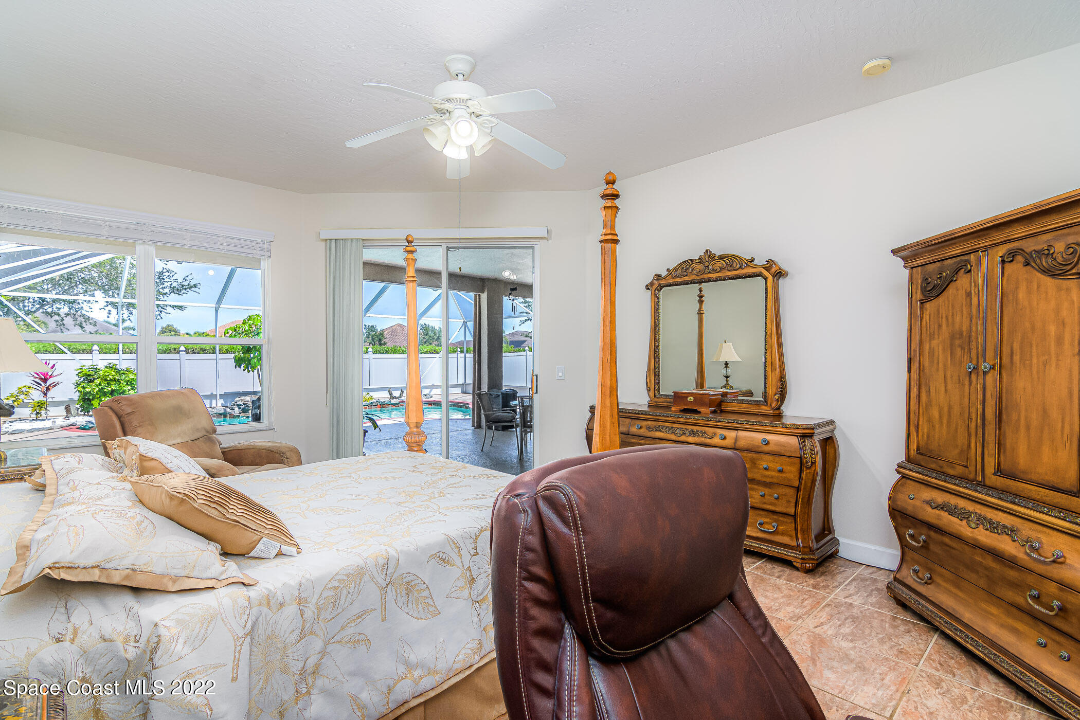3832 Stream Drive Melbourne, FL 32940 - Photo 19 of 63 a bedroom with a bed and wooden floor