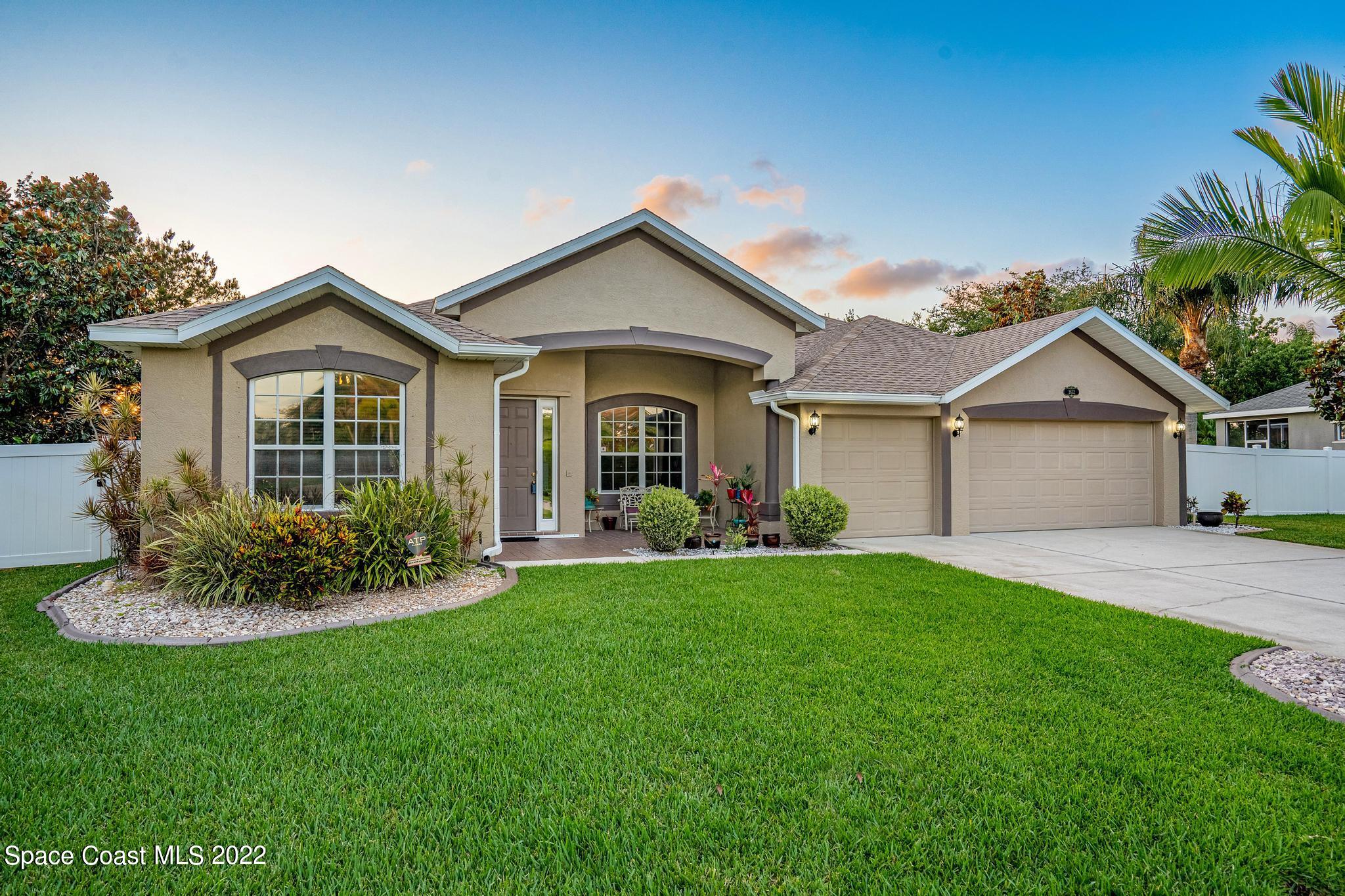 3832 Stream Drive Melbourne, FL 32940 - Photo 2 of 63 a front view of a house with a yard and garage