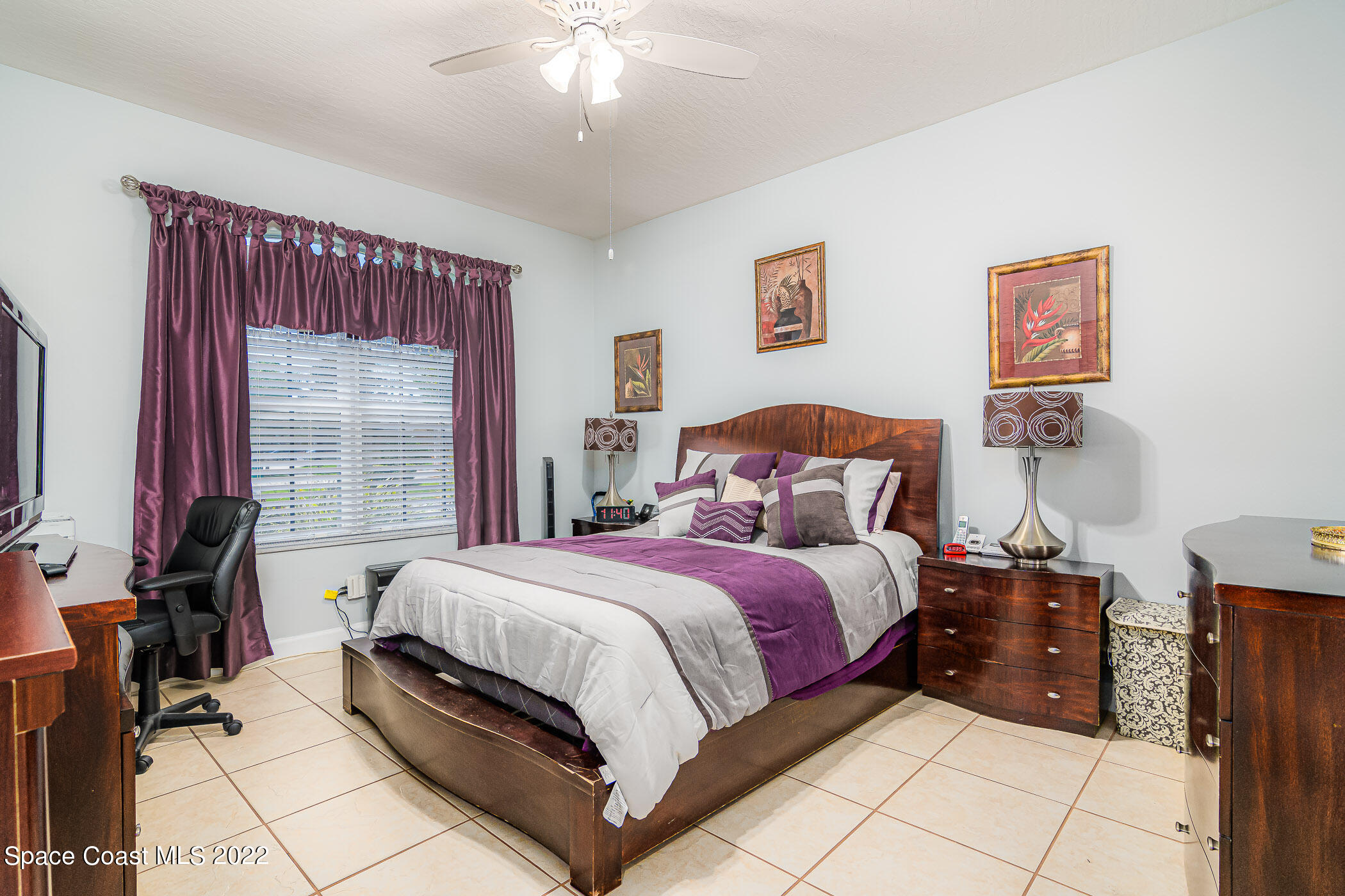 3832 Stream Drive Melbourne, FL 32940 - Photo 22 of 63 a bedroom with a bed and a chandelier