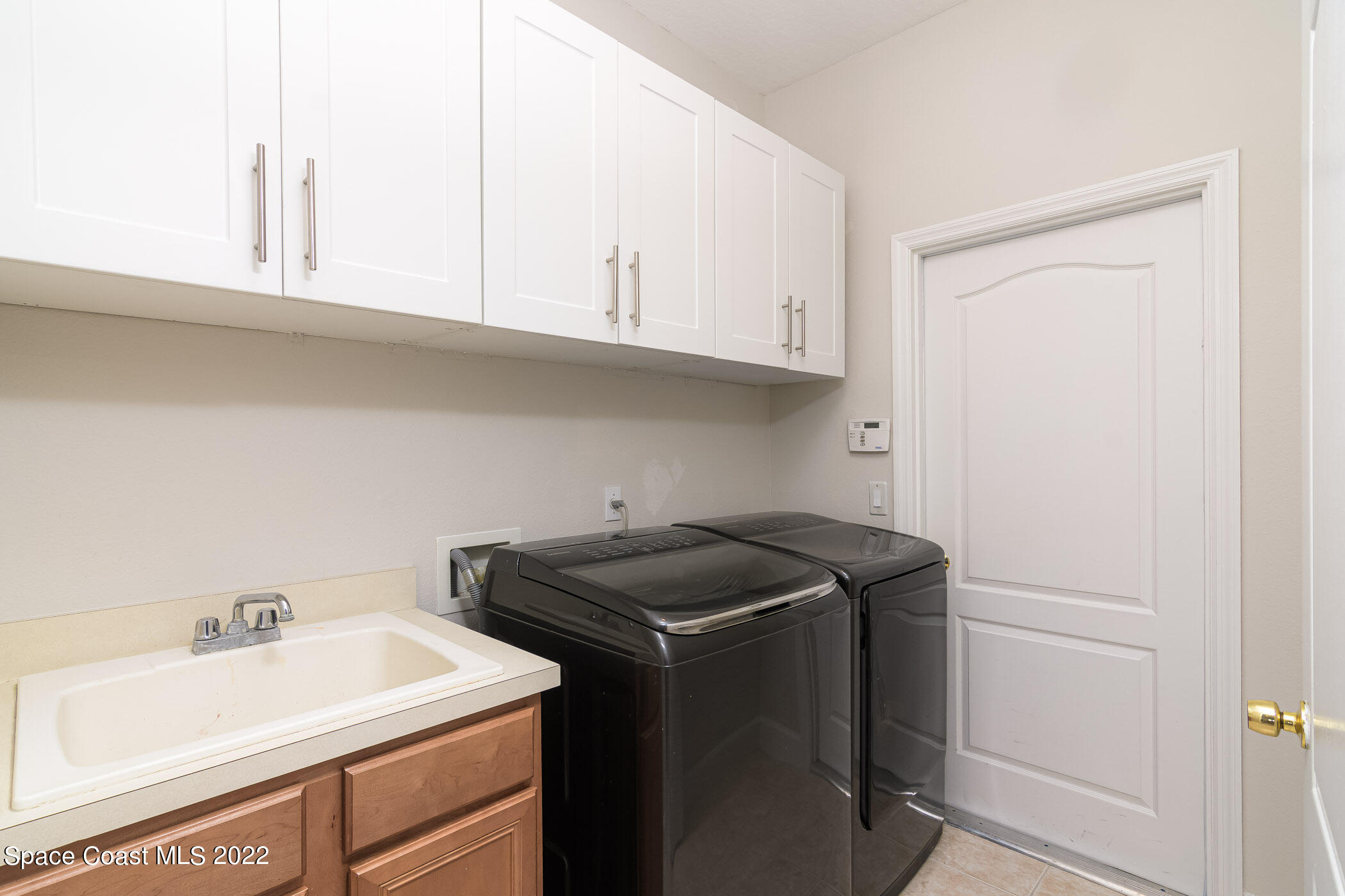 3832 Stream Drive Melbourne, FL 32940 - Photo 27 of 63 a utility room with sink dryer and washer