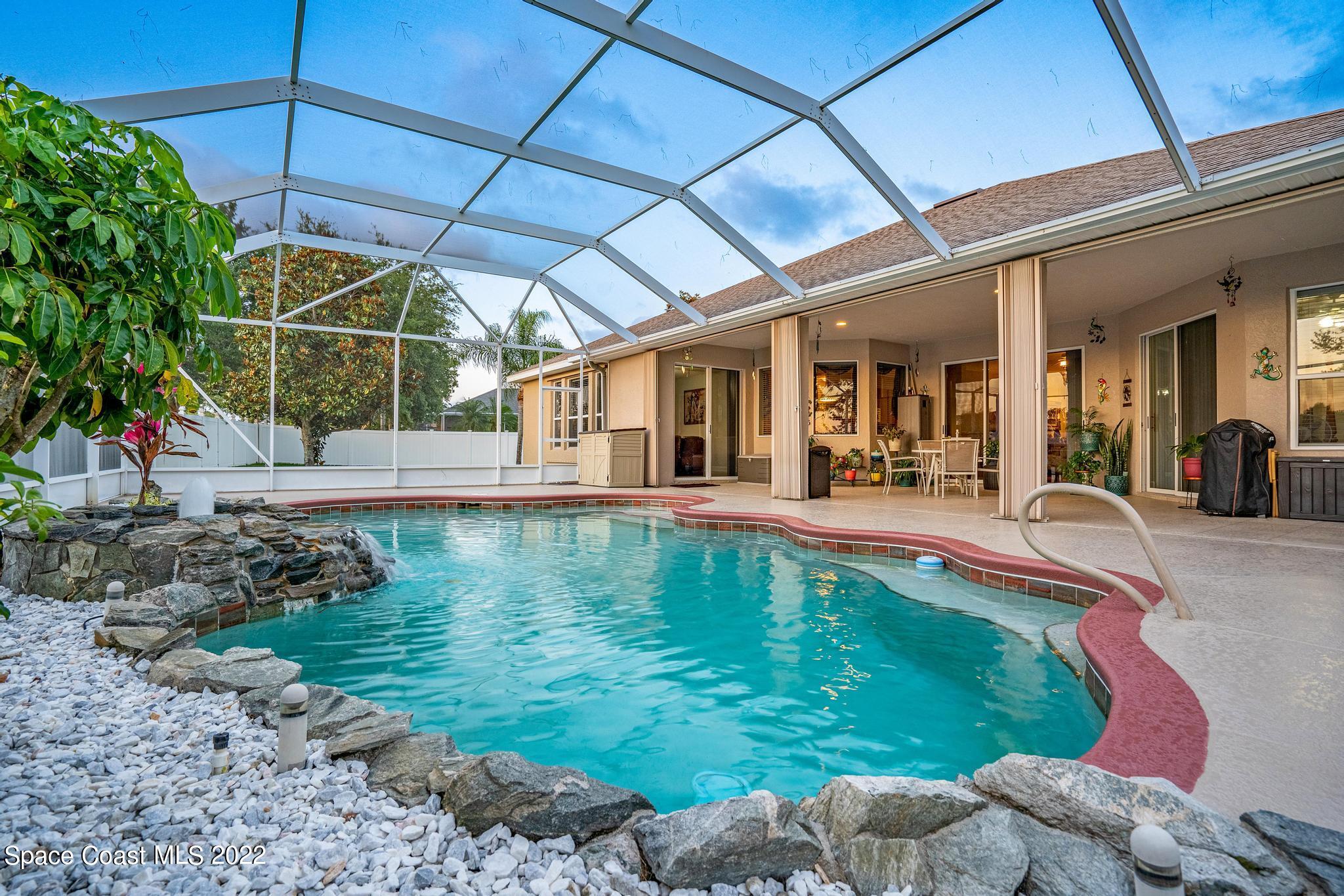 3832 Stream Drive Melbourne, FL 32940 - Photo 28 of 63 a swimming pool with outdoor seating