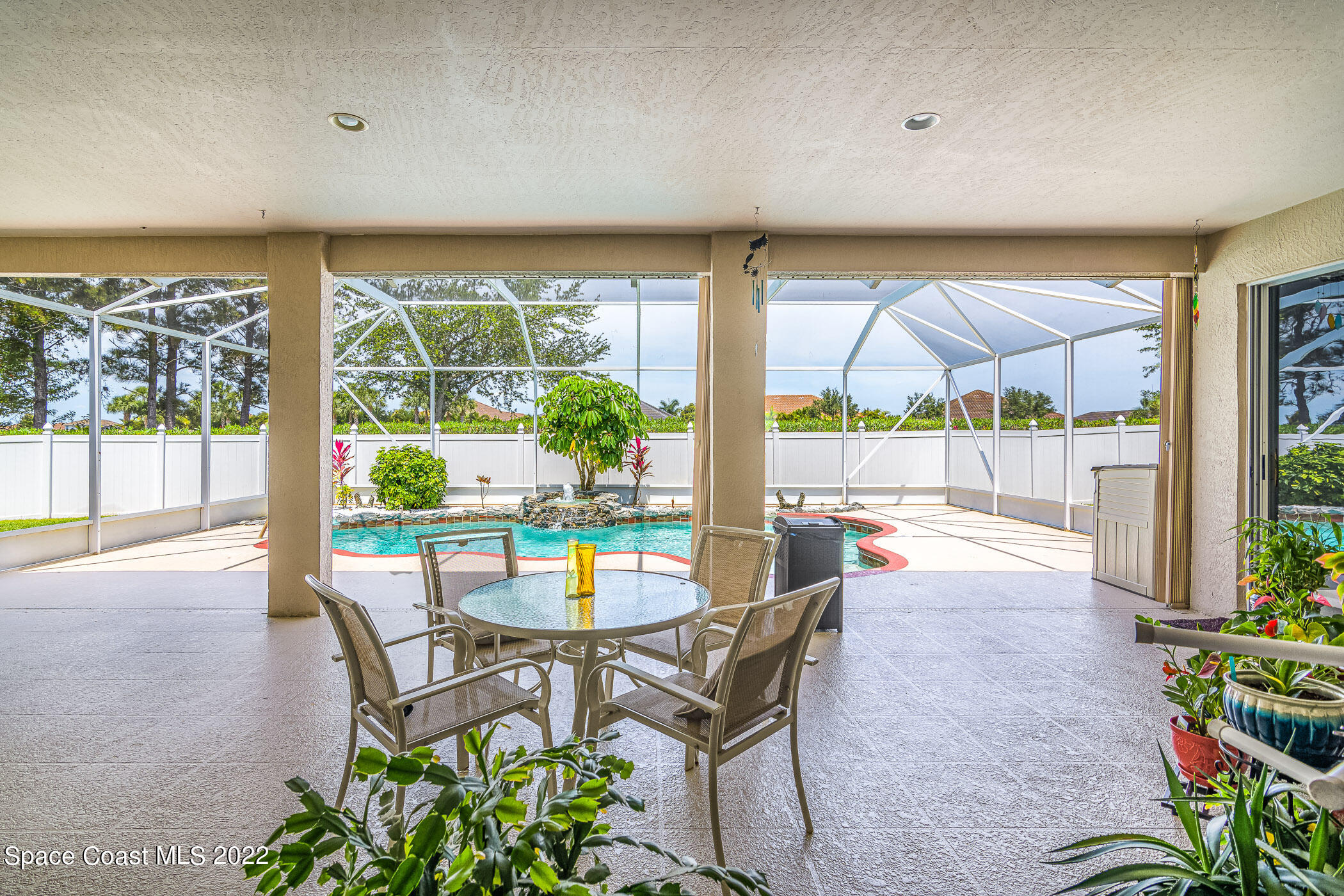 3832 Stream Drive Melbourne, FL 32940 - Photo 33 of 63 a dining room with furniture and a floor to ceiling window