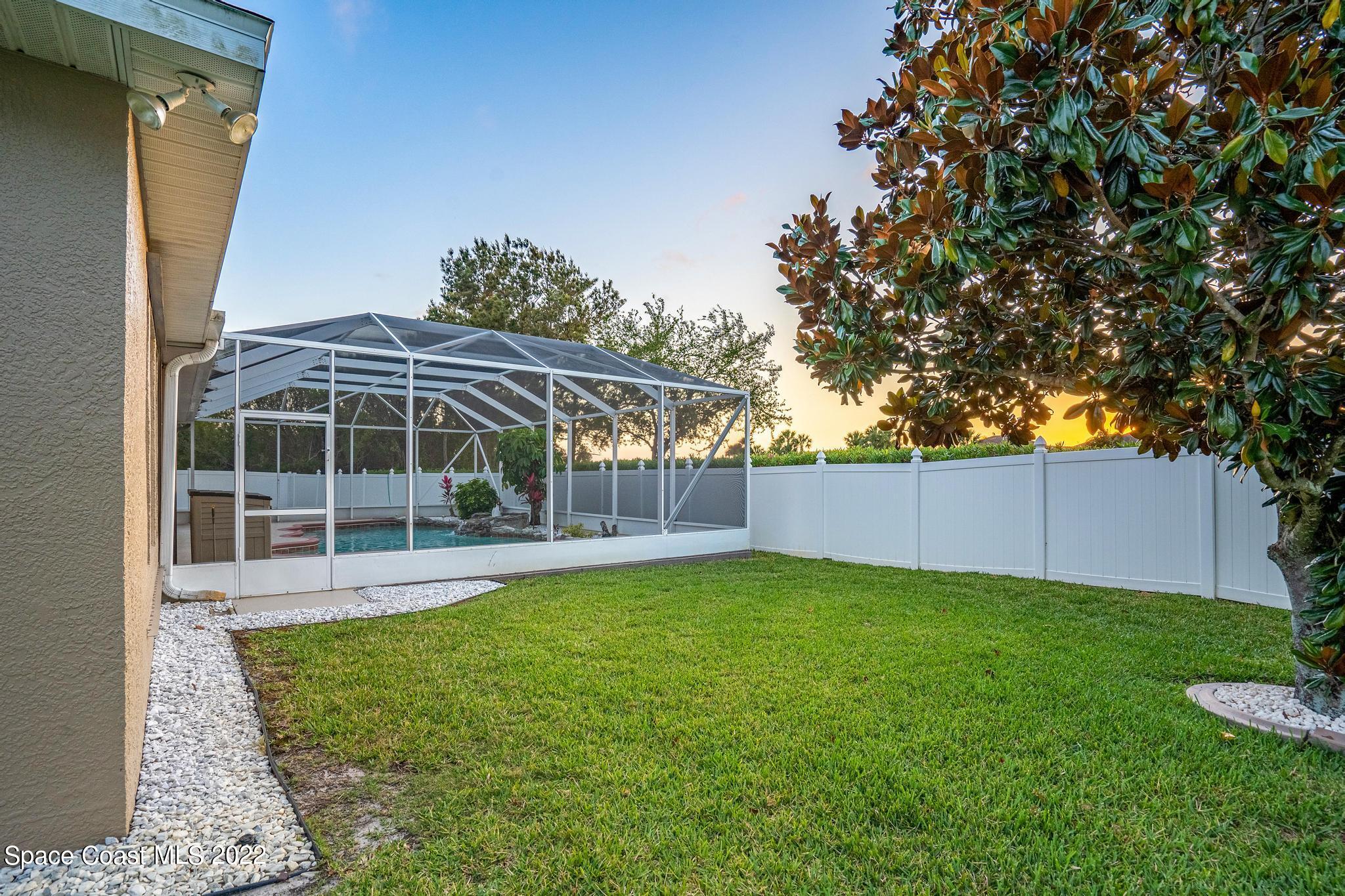 3832 Stream Drive Melbourne, FL 32940 - Photo 36 of 63 a view of a house with backyard and a garden