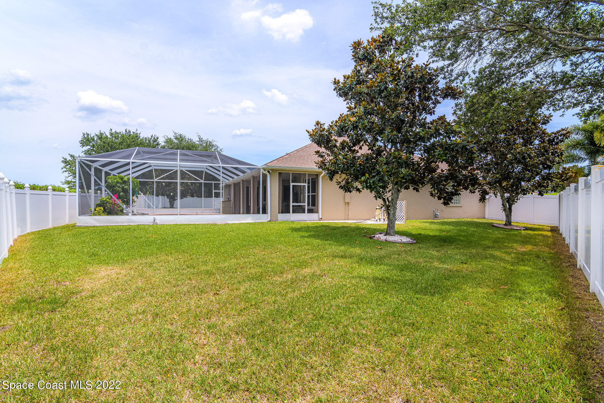 3832 Stream Drive Melbourne, FL 32940 - Photo 38 of 63 a house view with swimming pool and trees in the background