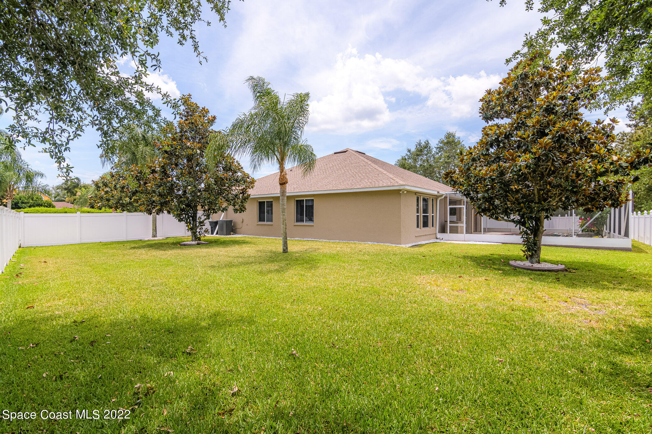 3832 Stream Drive Melbourne, FL 32940 - Photo 39 of 63 a swimming pool with some trees in the background