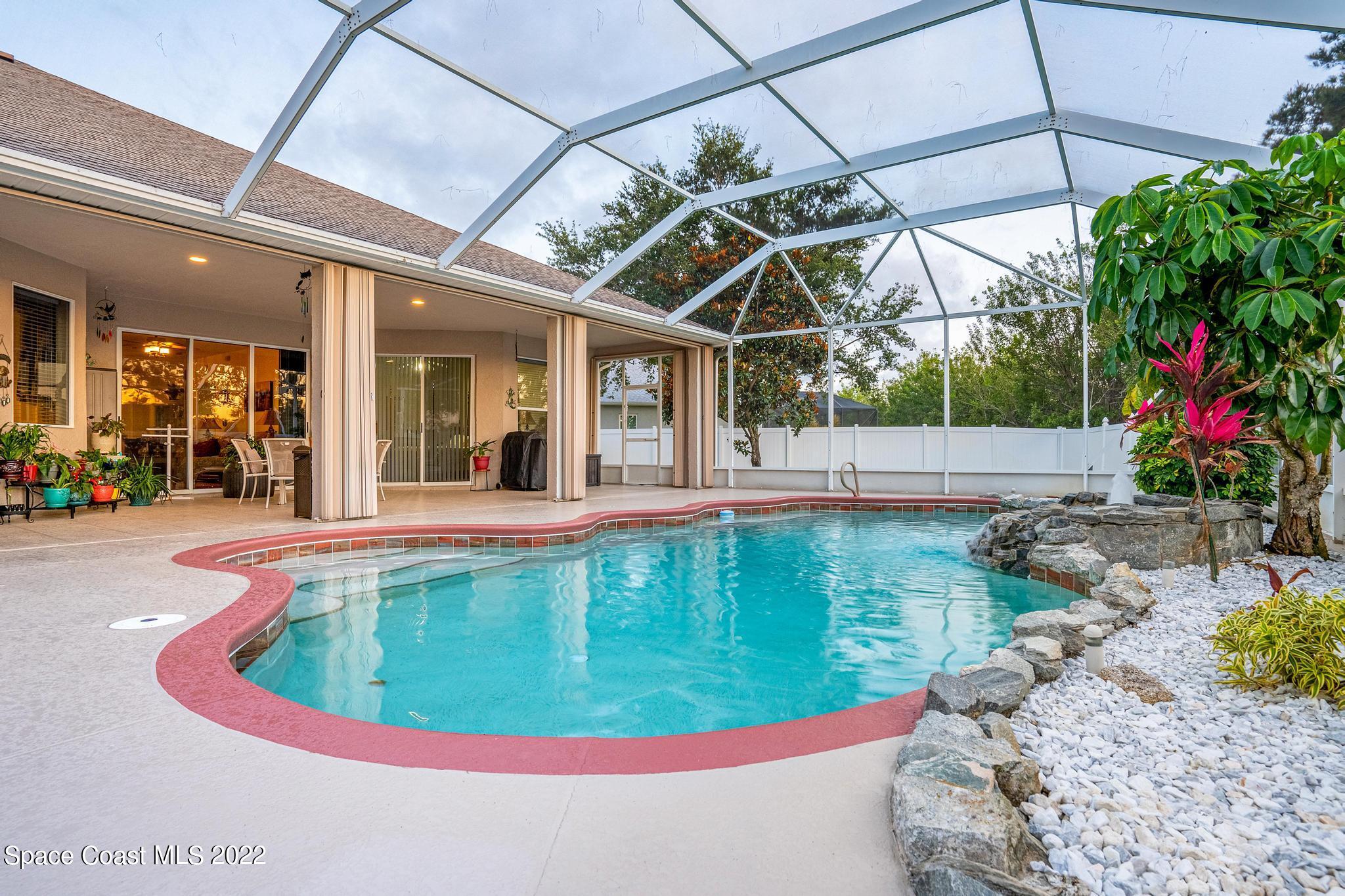 3832 Stream Drive Melbourne, FL 32940 - Photo 40 of 63 a view of a swimming pool with a porch