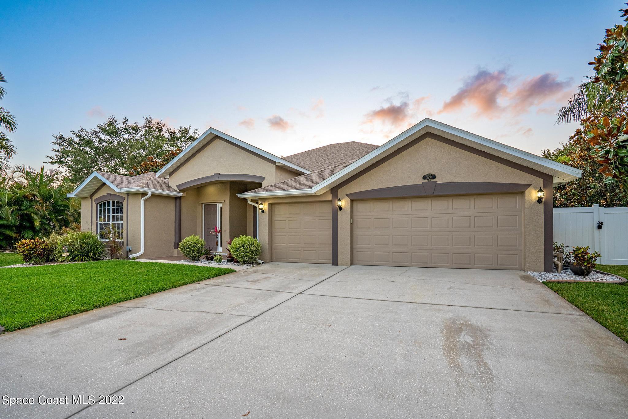 3832 Stream Drive Melbourne, FL 32940 - Photo 51 of 63 a front view of a house with a yard and garage