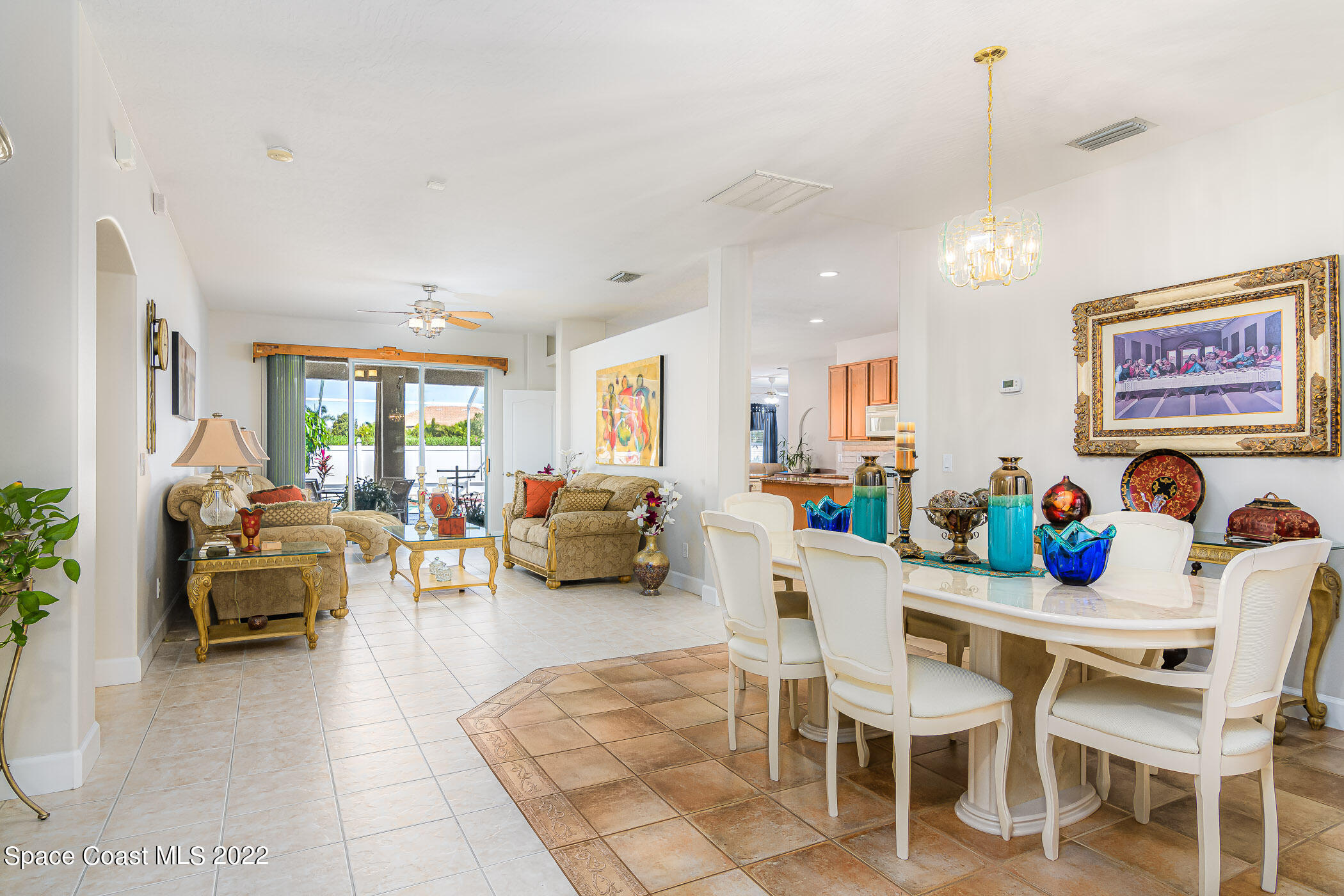 3832 Stream Drive Melbourne, FL 32940 - Photo 9 of 63 a view of a dining room and livingroom with furniture wooden floor a rug and a chandelier