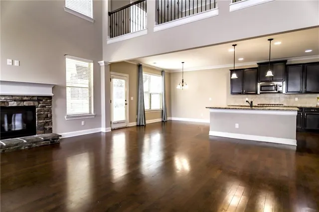 a view of a kitchen with a stove wooden floor and a fireplace