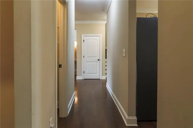 a view of a hallway with a wooden door