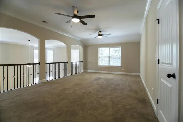 a view of a livingroom with a ceiling fan and window