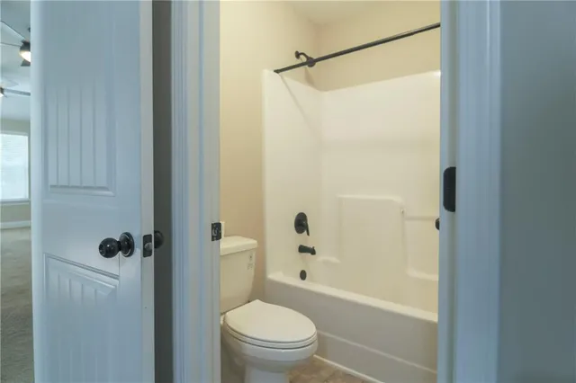 a bathroom with a shower a toilet and a shower