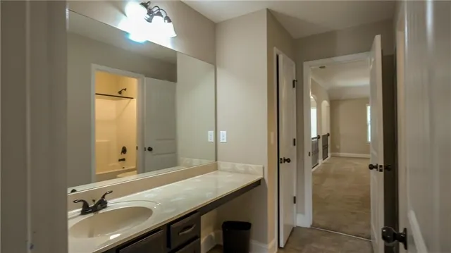 a bathroom with a sink and mirror
