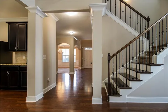 a view of an entryway with wooden floor and stairs