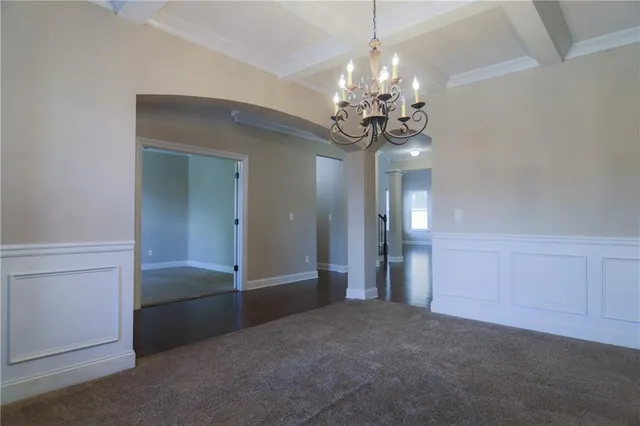 a view of a chandelier in big room and chandelier