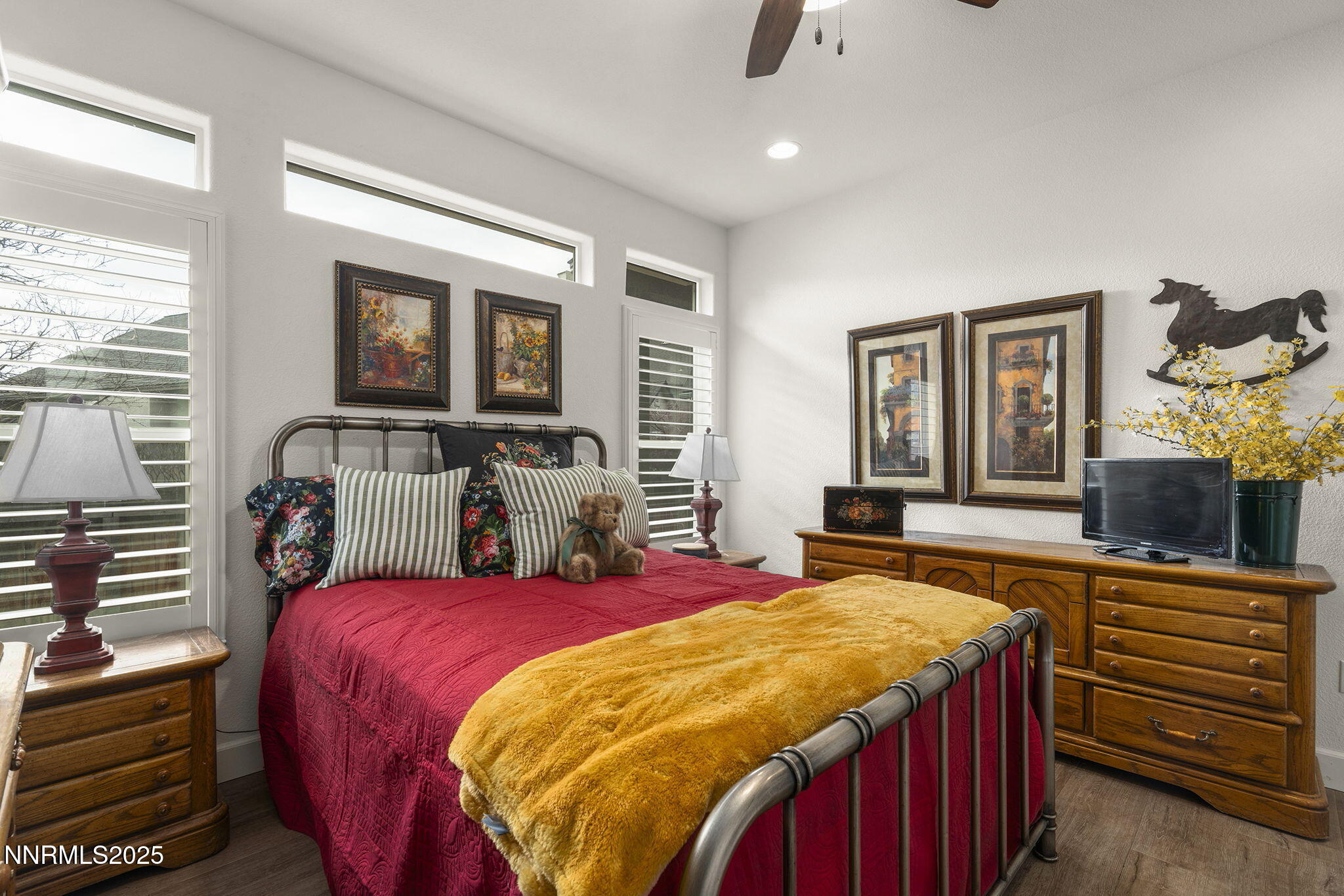 985 Floral Ridge Way Sparks, NV 89436 - Photo 16 of 24 a bed sitting in a bedroom next to a window with a flat tv screen and a dresser